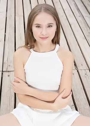 Sasha Quinn Smiling Playfully As Her Short Skirt Flips Up To Reveal She’s Not Wearing Panties